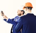 Profession, inspection, work, building, engineering concept. Project manager with smartphone shows something with his