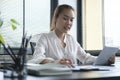 Professional accountant using calculator and checking financial reports at office desk Royalty Free Stock Photo