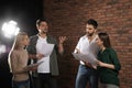 Professional actors reading scripts during rehearsal in theatre