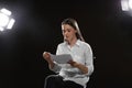 Professional actress reading her script during rehearsal in theatre