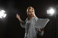 Professional actress reading her script during rehearsal in theatre