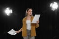 Professional actress reading her script during rehearsal in theatre