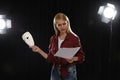 Professional actress reading her script during rehearsal in theatre