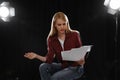 Professional actress reading her script during rehearsal in theatre