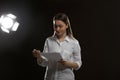 Professional actress reading script during rehearsal in theatre