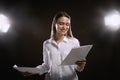 Professional actress reading script during rehearsal in theatre