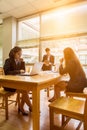 Professional administrative short black hair asian business woman hold book in hand and work with ladies co-worker in Royalty Free Stock Photo