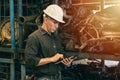 Professional adult Engineer male attending duty work in factory working checking stock inventory data with tablet computer