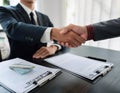 Professional agent and client interaction featuring elements like a handshake, business card, and contract symbolizing