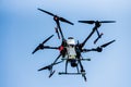 Professional agriculture drone flying in the blue sky