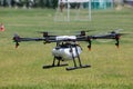 Professional agriculture drone on the green field during the tes