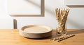 Stack of Biodegradable Plates and Striped Paper Straws for Sustainable Hospitality and Zero Waste Events. Royalty Free Stock Photo
