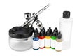 Professional airbrush starter set equipment with chrome metal gun acrylic paint and thinner bottles isolated white background. Royalty Free Stock Photo