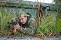 A professional airsoft player aims at his opponents.