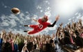 Professional american football player flies over hands of fans and catching a touchdown pass. Royalty Free Stock Photo