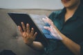 Professional analyzing complex data with a futuristic holographic display interface over a tablet, demonstrating cutting