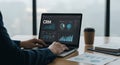 Professional Analyzing CRM Data on Laptop in Modern Office Royalty Free Stock Photo