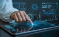 Professional analyzing data visualizations on a digital tablet interface with futuristic elements Royalty Free Stock Photo