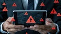 A professional appears anxious while checking a warning message on his phone, surrounded by coding screens in a