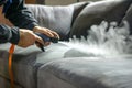 professional applying protective spray to a sofa after a deep clean Royalty Free Stock Photo