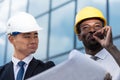 Professional architects in hardhats working with blueprint Royalty Free Stock Photo