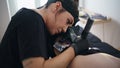 Professional artist tattooing skin salon closeup. Focused woman working machine