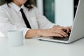 Professional Asian aged businesswoman working at her desk, using laptop, typing on keyboard Royalty Free Stock Photo