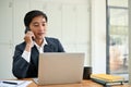 A professional Asian businessman is on the phone, counseling his business client Royalty Free Stock Photo