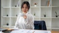 A professional Asian businesswoman focuses on reading, analyzing, and examining financial reports Royalty Free Stock Photo