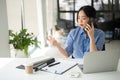 A professional Asian businesswoman is having a serious phone call with a client Royalty Free Stock Photo