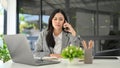 Professional Asian businesswoman having a serious phone call while working in her office Royalty Free Stock Photo