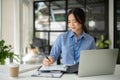 A professional Asian businesswoman is signing documents and working on her business work Royalty Free Stock Photo