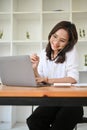 Professional Asian businesswoman talking on the phone with her business client Royalty Free Stock Photo