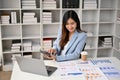 Professional Asian businesswoman working on business financial data at her desk Royalty Free Stock Photo