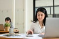 Asian female accountant managing her financial tasks and working at her office desk Royalty Free Stock Photo