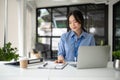 A professional Asian female accountant is working on her business work at her desk Royalty Free Stock Photo