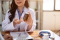 A professional Asian female doctor is describing pills to a patient. cropped image Royalty Free Stock Photo