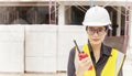 Professional Asian female engineer or architect working in the field at a construction site. Royalty Free Stock Photo