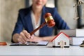 A professional Asian female lawyer pr attorney holding a judge gavel or judge hammer at her desk Royalty Free Stock Photo