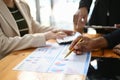 Professional Asian male financial analyst pointing his pen on financial report, analyzing data Royalty Free Stock Photo