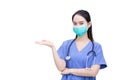 Professional Asian woman doctor wears medical clothing and medical face mask to protect virus while shows her hand to suggest Royalty Free Stock Photo