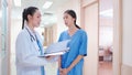 Professional, Asian young female medical doctor, staff in uniform standing in hospital corridor. Royalty Free Stock Photo