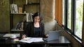 A businesswoman focuses on her work, reviewing marketing reports at her desk Royalty Free Stock Photo