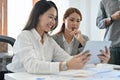 A professional young Asian businesswoman working with her team Royalty Free Stock Photo