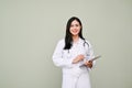 Attractive Asian female doctor holding tablet, smiling and looking at camera Royalty Free Stock Photo
