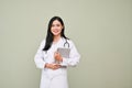 Professional Asian female doctor holding tablet, standing over isolated grey background Royalty Free Stock Photo