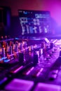Professional audio mixing board connected to a laptop, displaying the various knobs and buttons. Royalty Free Stock Photo