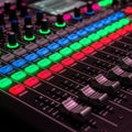 Professional audio mixing console illuminated with vibrant colored Royalty Free Stock Photo