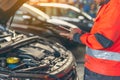 Auto mechanic performing car diagnostic at modern service station. AI Generated Royalty Free Stock Photo