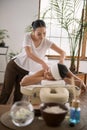 Joyful young masseuse doing her work Royalty Free Stock Photo